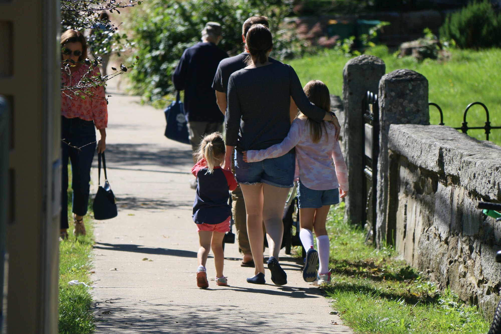 A family walking together down a sidewalk